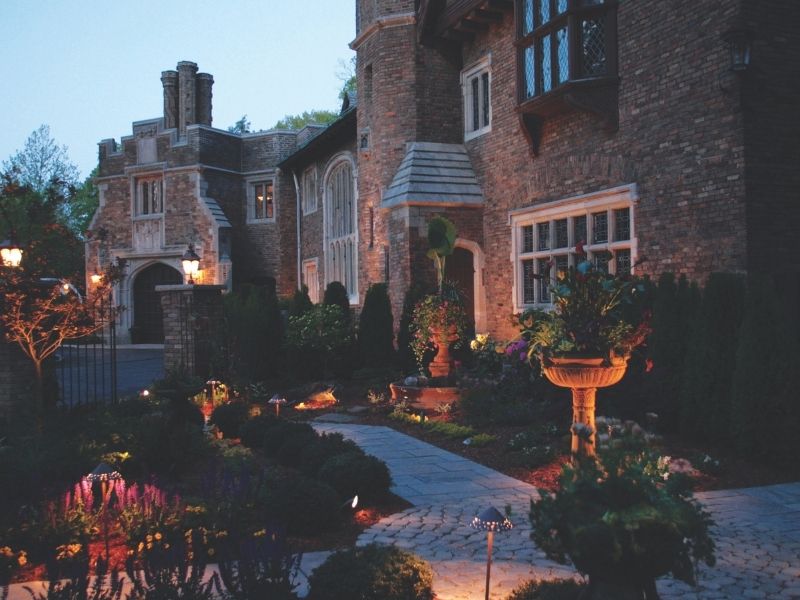 Elegant brick home with lit garden at dusk (2)