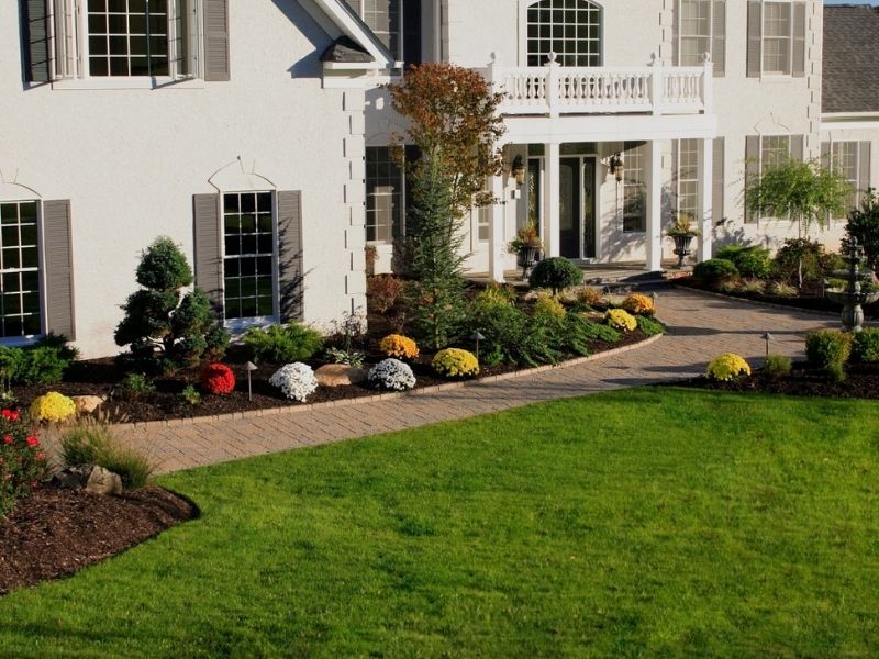 Large house with manicured lawn and landscaping