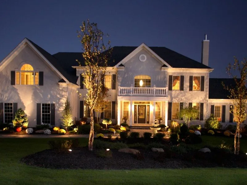 Landscape lighting highlighting the home's entrance and garden